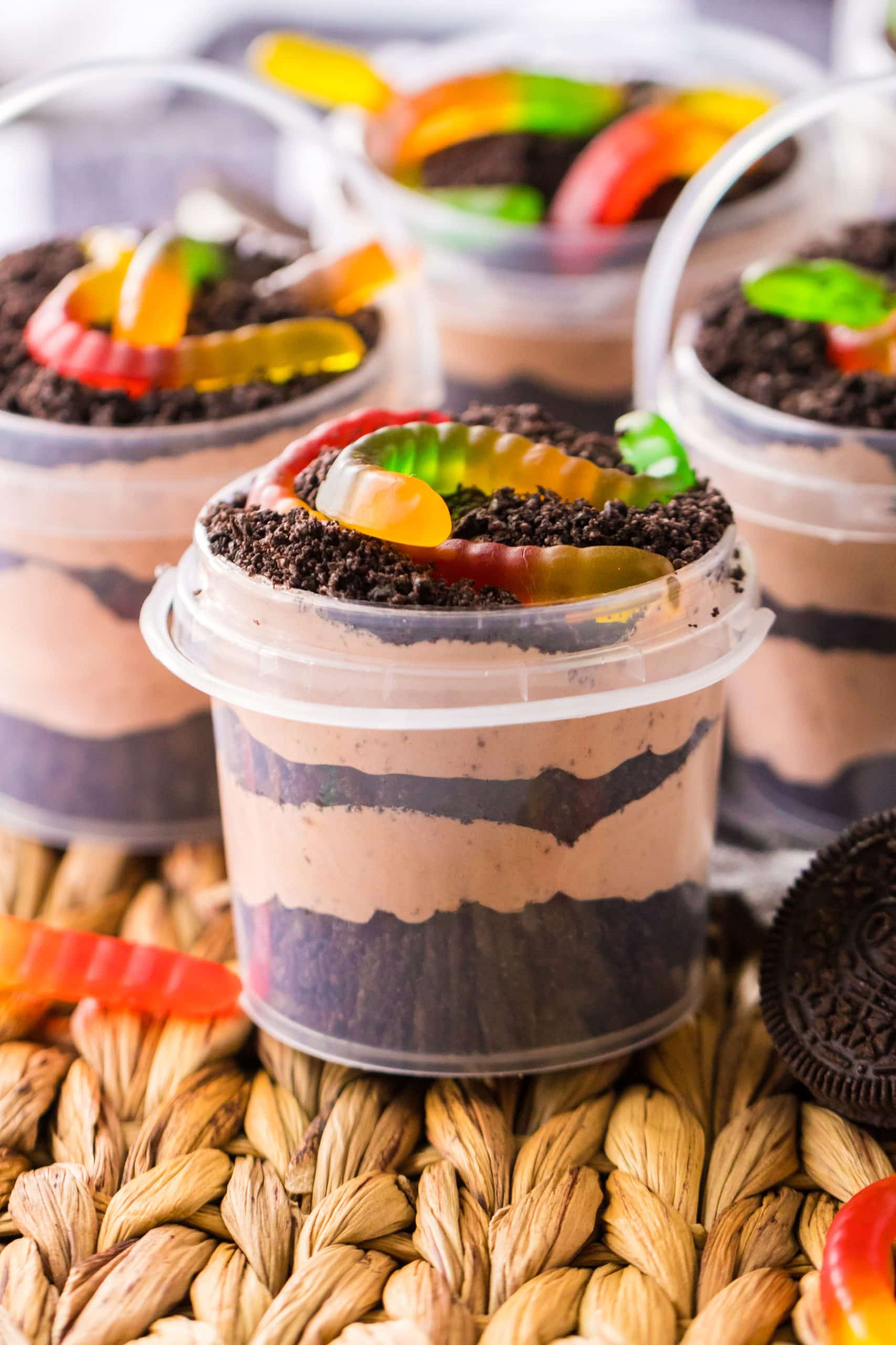 small clear plastic buckets filled with layers of dirt pudding recipe