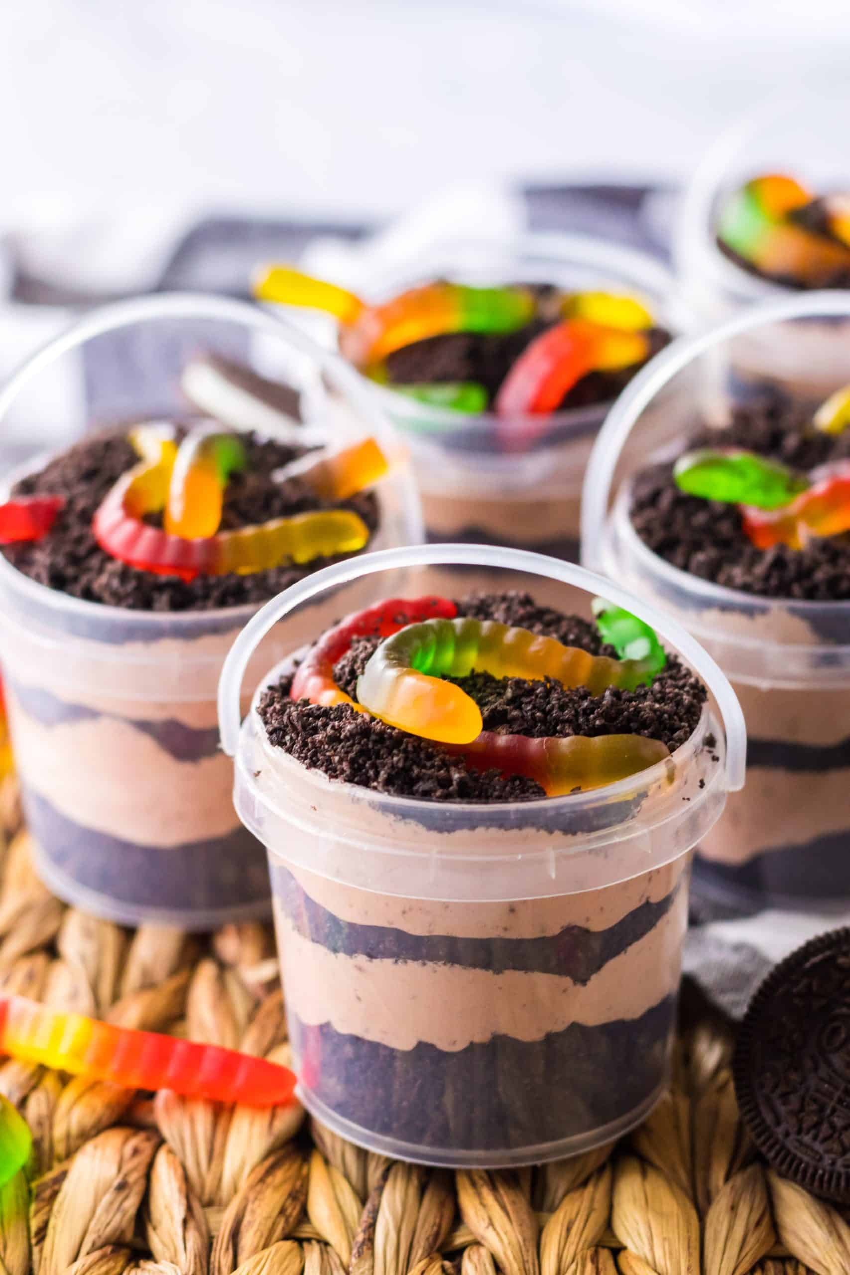 Summer Dirt Cake Cups in Buckets on a wicker placemat