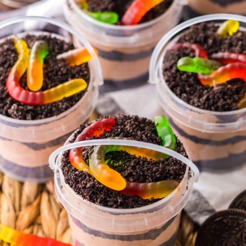 Summer Dirt Cake Cups in Buckets on a wicker placemat