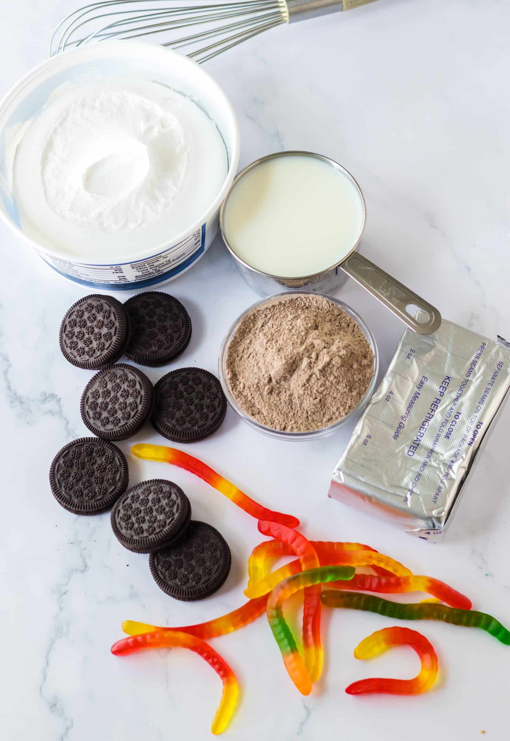 an overhead image showing the measured ingredients needed to make summer dirt cup cakes in buckets