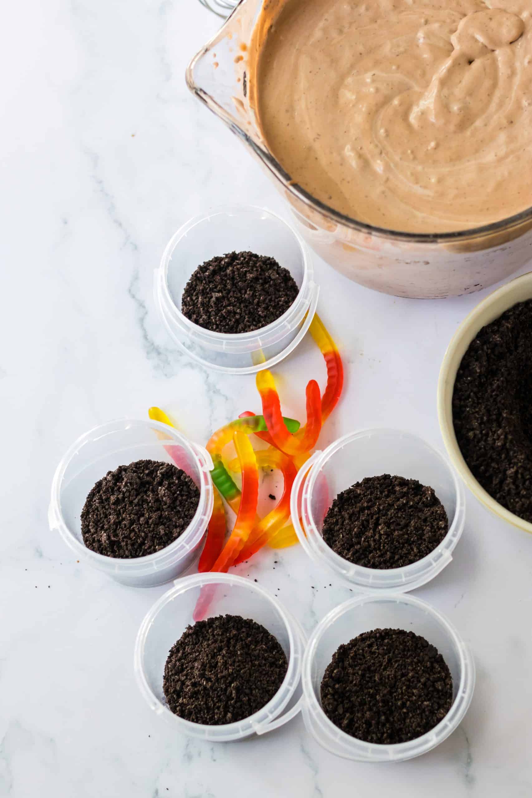 crushed oreo cookies in small pastic buckets