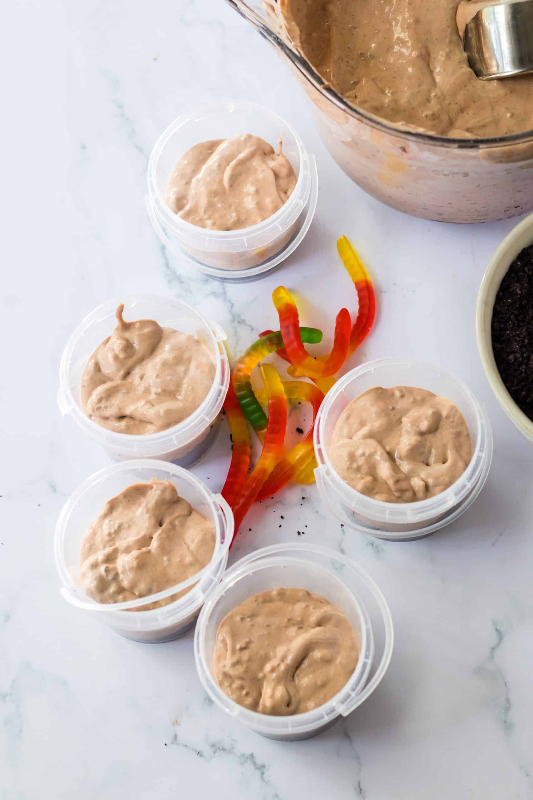 chocolate pudding layered in small plastic buckets