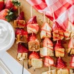 strawberry and pound cake skewers on a white platter