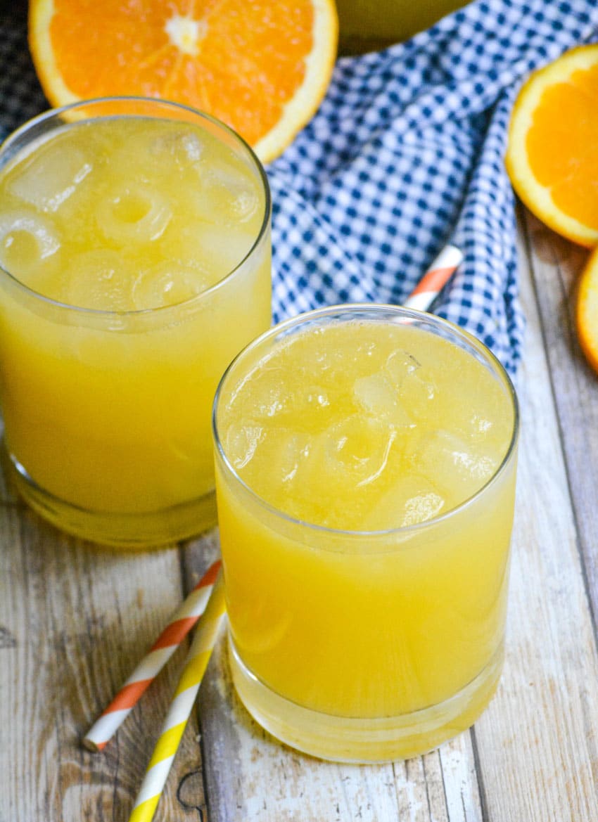 two glasses of homemade orangeade on a wooden table