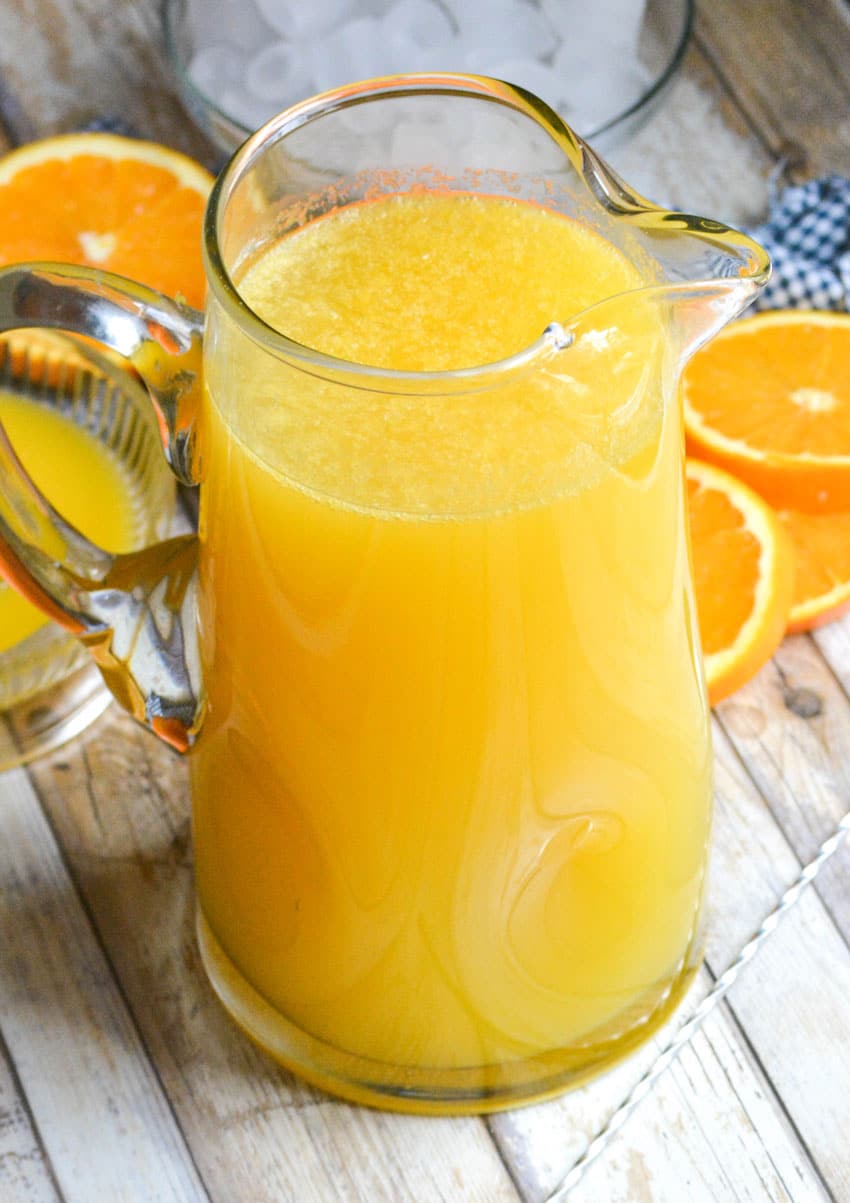 a homemade orangeade recipe in a large glass pitcher 