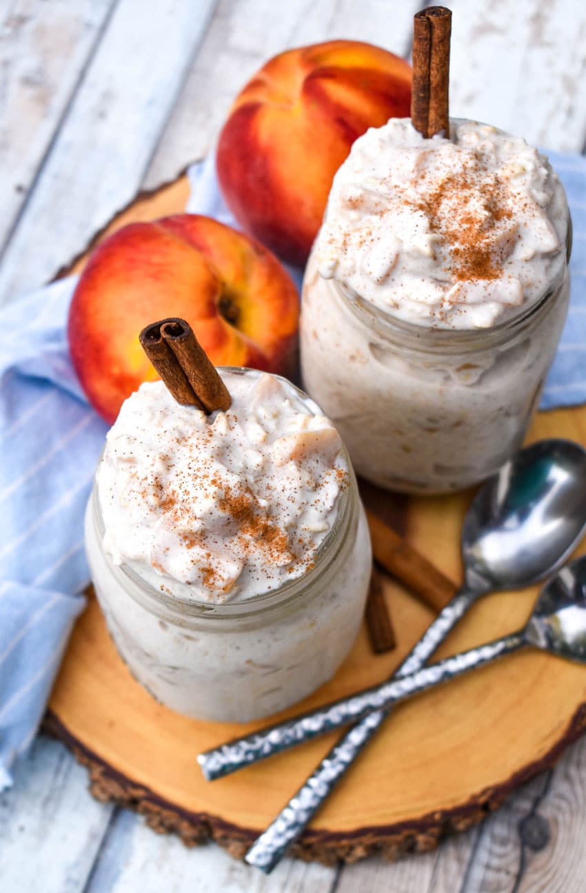 peaches and cream overnight oats in two glass mason jars