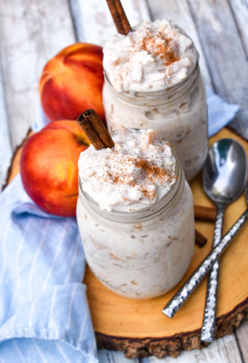 peaches and cream overnight oats in two glass mason jars