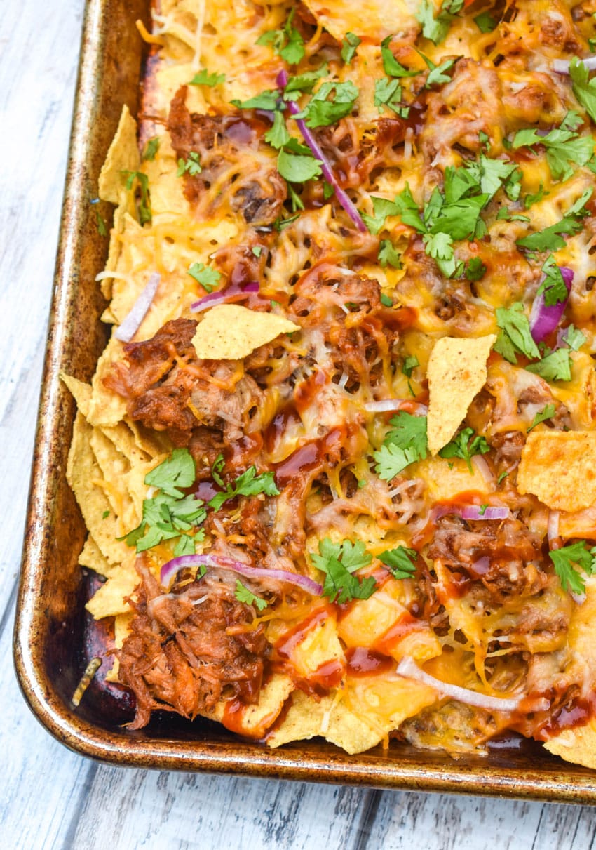 barbecue pulled pork nachos on a metal sheet pan