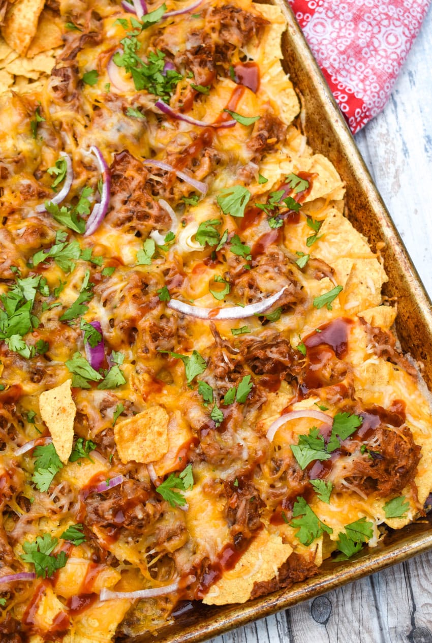 barbecue pulled pork nachos on a metal sheet pan