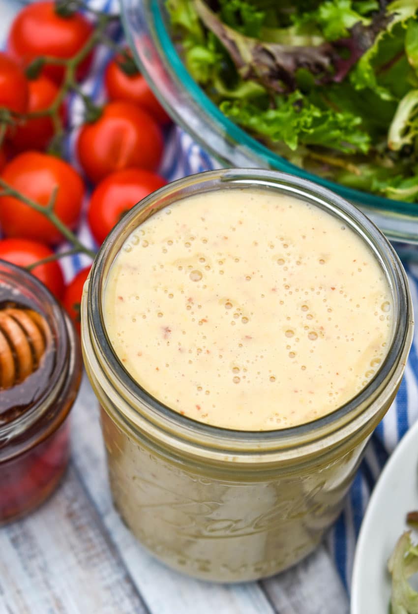 easy honey mustard dressing in a glass mason jar