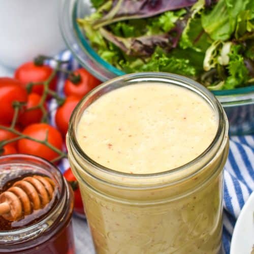 easy honey mustard dressing in a glass mason jar