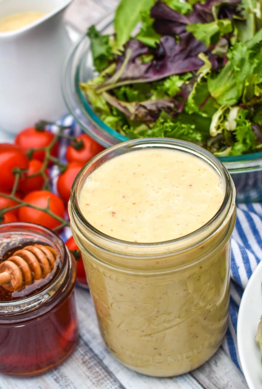 easy honey mustard dressing in a glass mason jar