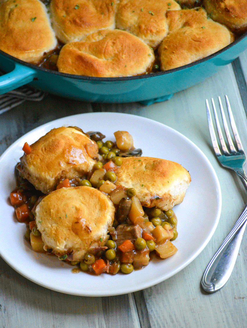 easy beef pot pie recipe with biscuit topping served on a white dinner plate