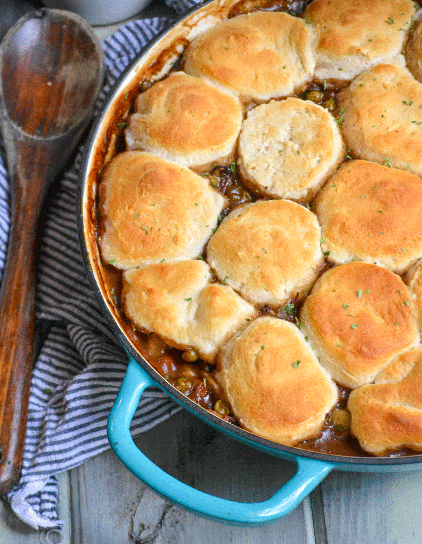 easy beef pot pie recipe with biscuit topping in a blue enameled cast iron skillet