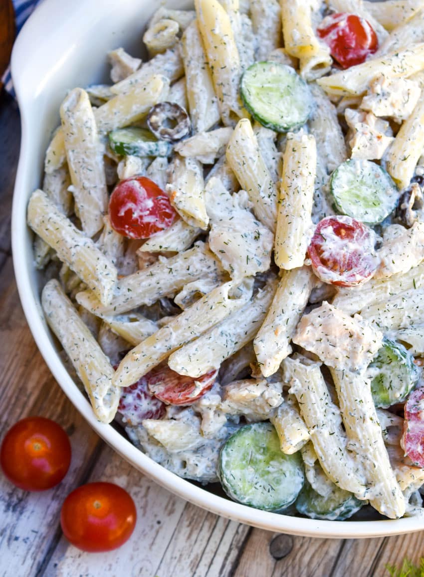 creamy Greek pasta salad in a white serving bowl