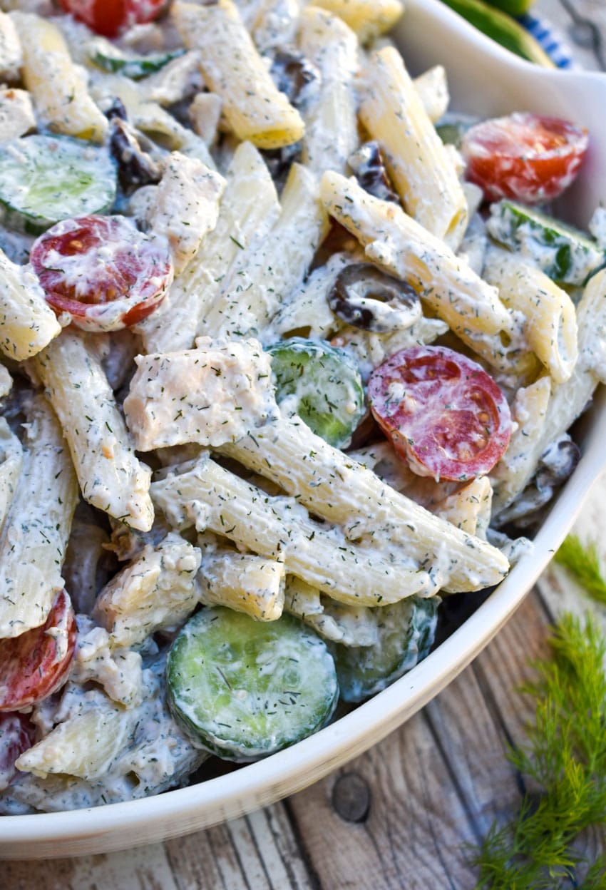 creamy Greek pasta salad in a white serving bowl