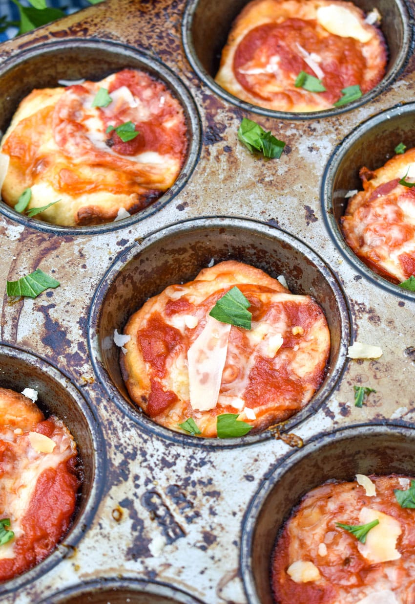 mini deep dish pizzas in a metal muffin tin