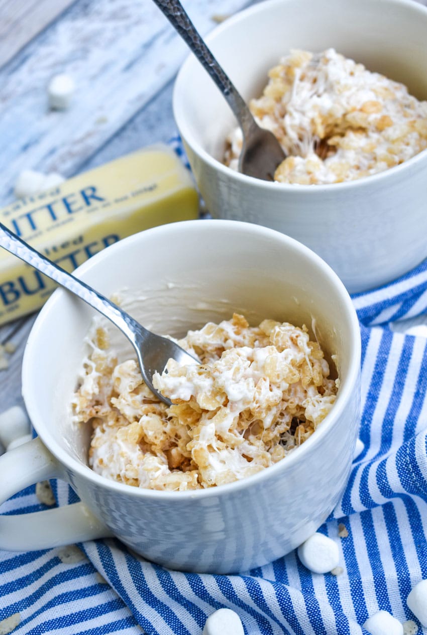 a silver fork stuck in a microwave rice krispie treat in a mug