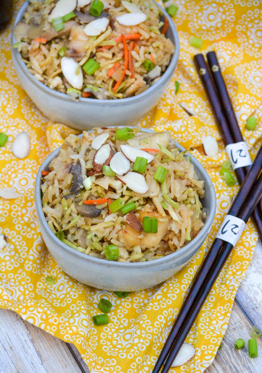 rice casserole with tilapia fish in two small gray bowls
