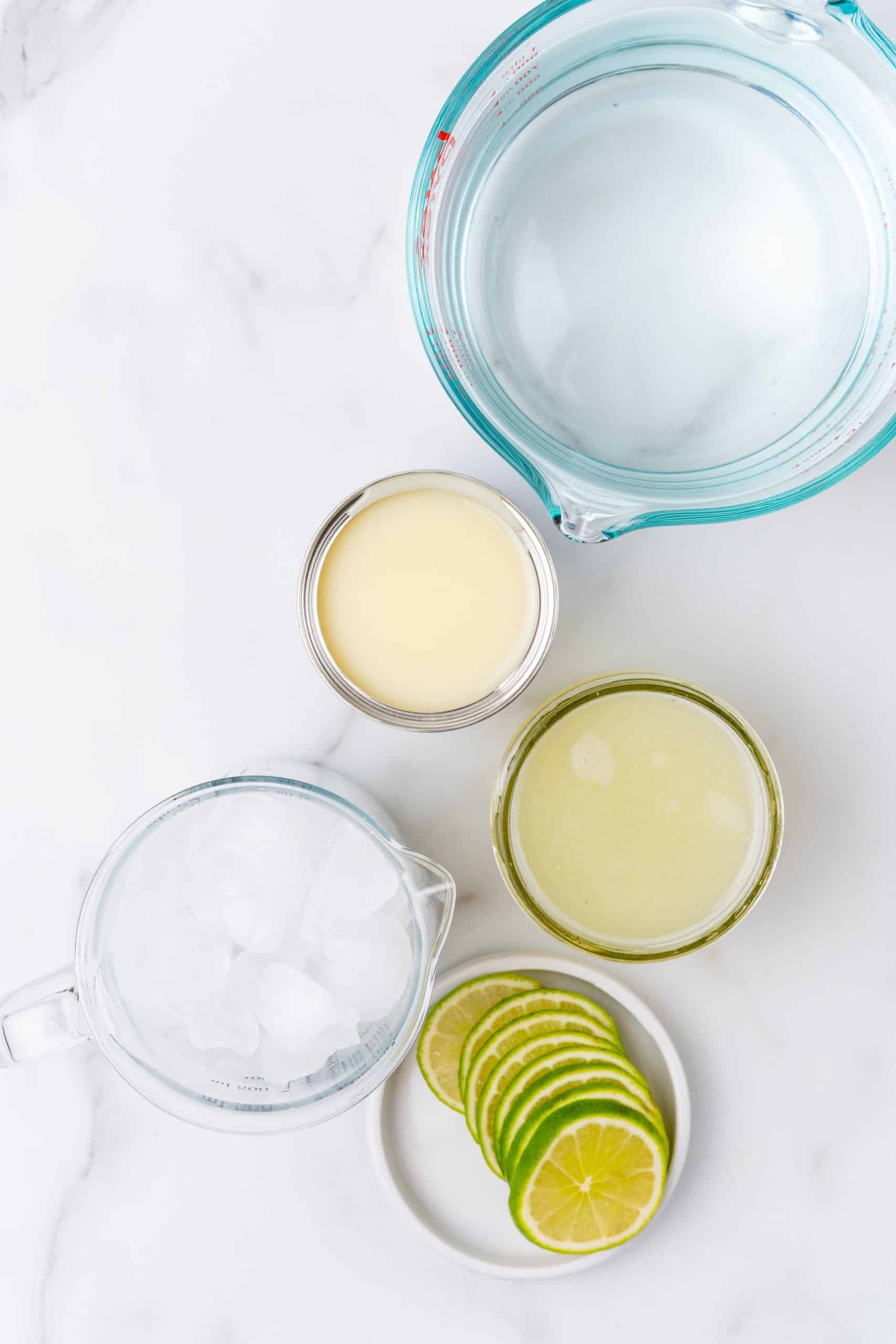an overhead image showing the measured ingredients needed to make a batch of Brazilian lemonade