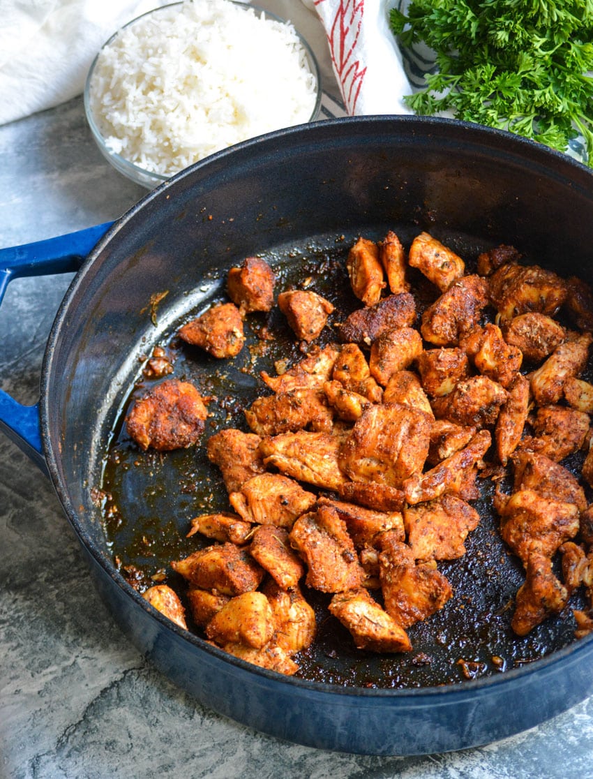 blackened chicken bites in a large cast iron skillet