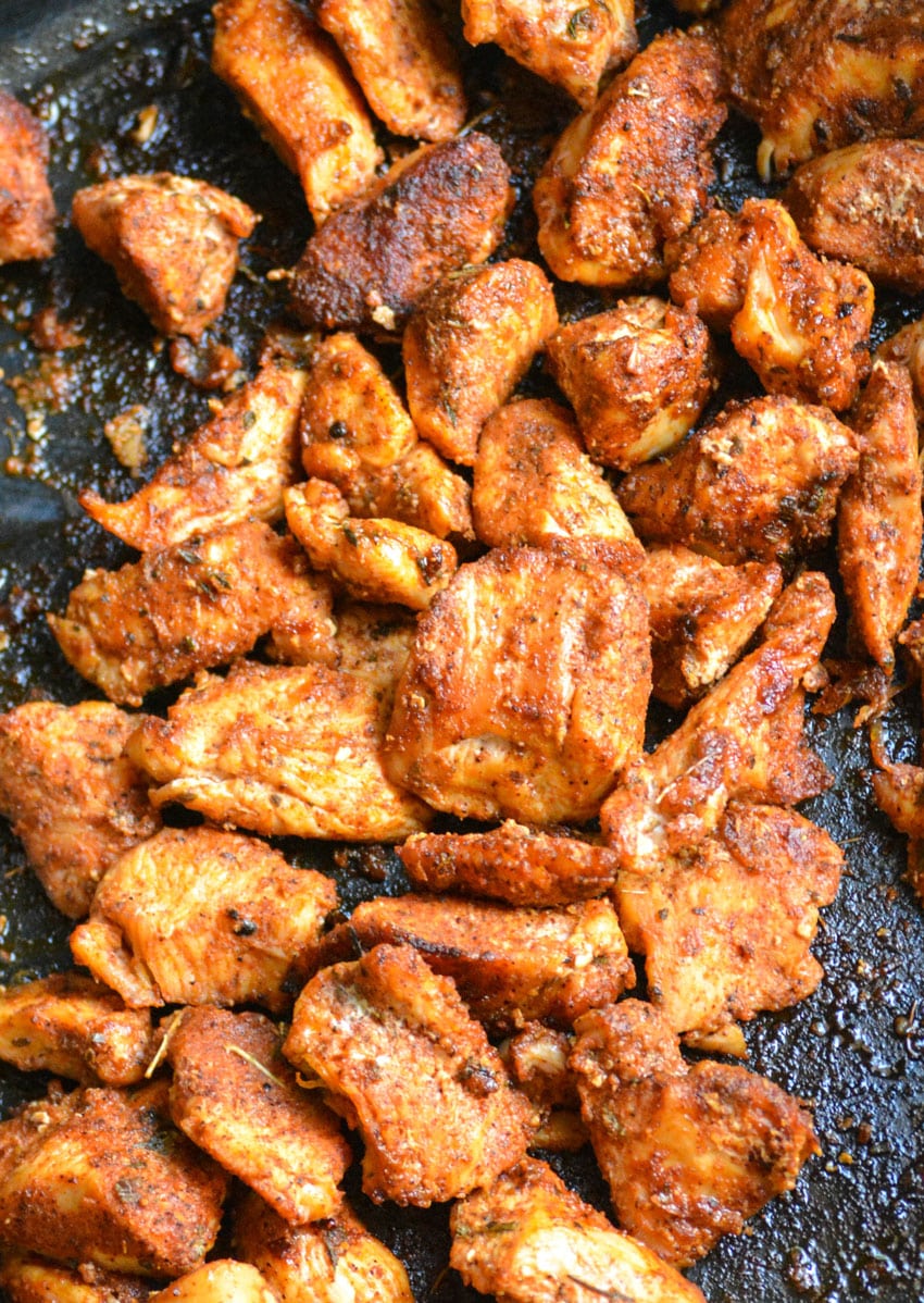 blackened chicken bites in a large cast iron skillet