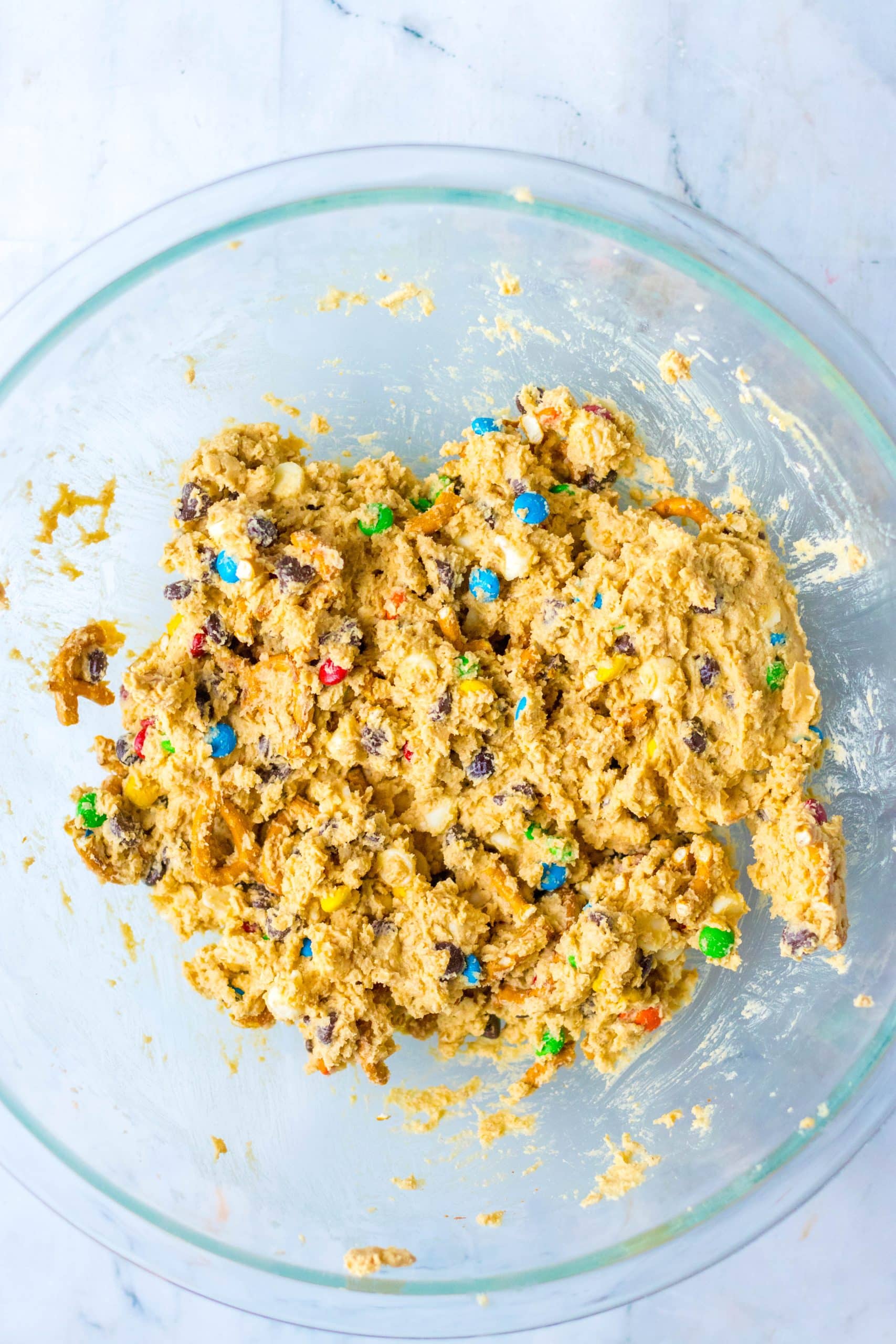 edible monster cookie dough in a large glass mixing bowl
