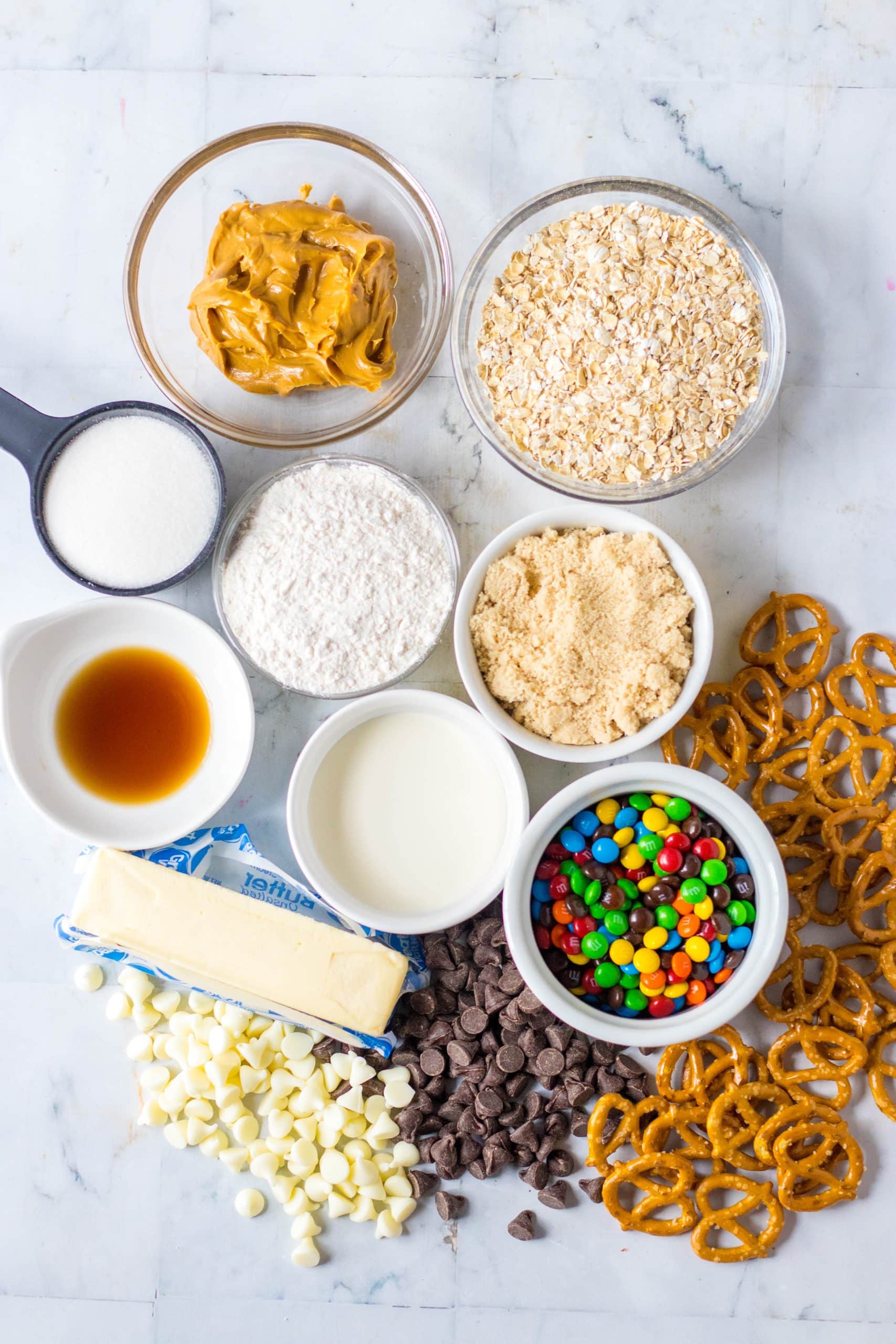 an overhead image showing the measured ingredients needed to make a batch of edible monster cookie dough