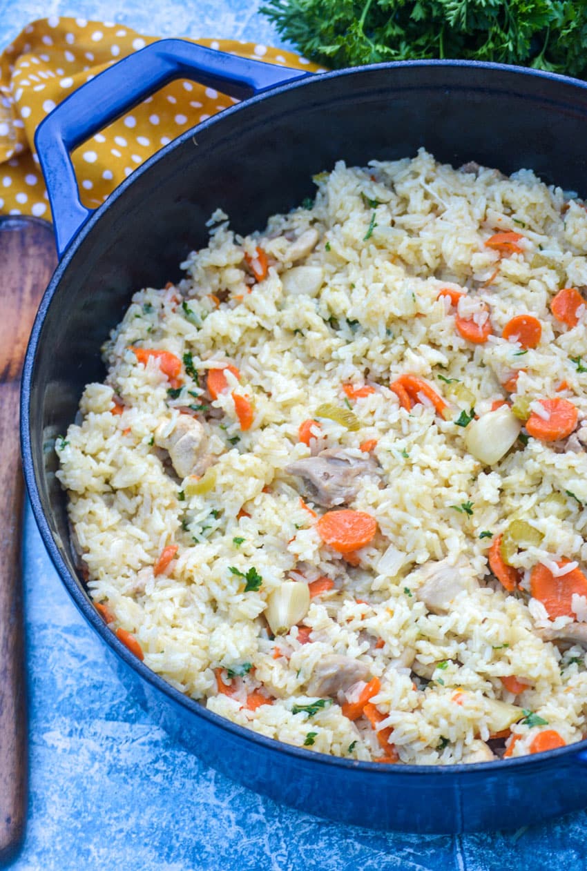 one pot chicken and rice with vegetables in a blue cast iron skillet