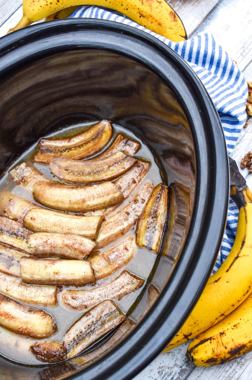 slow cooker bananas foster in the black bowl of a crockpot