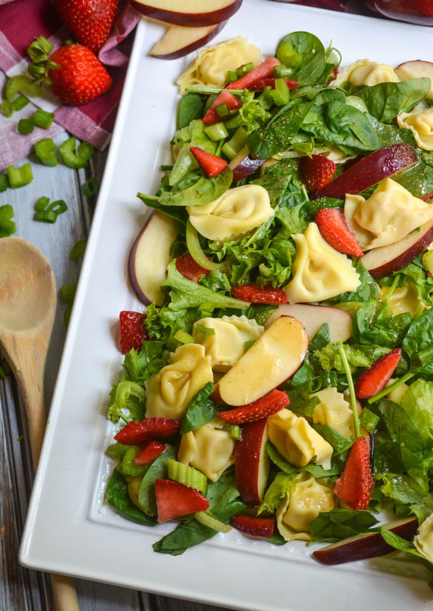 Apple Tortellini Salad With Strawberries on a large white serving platter