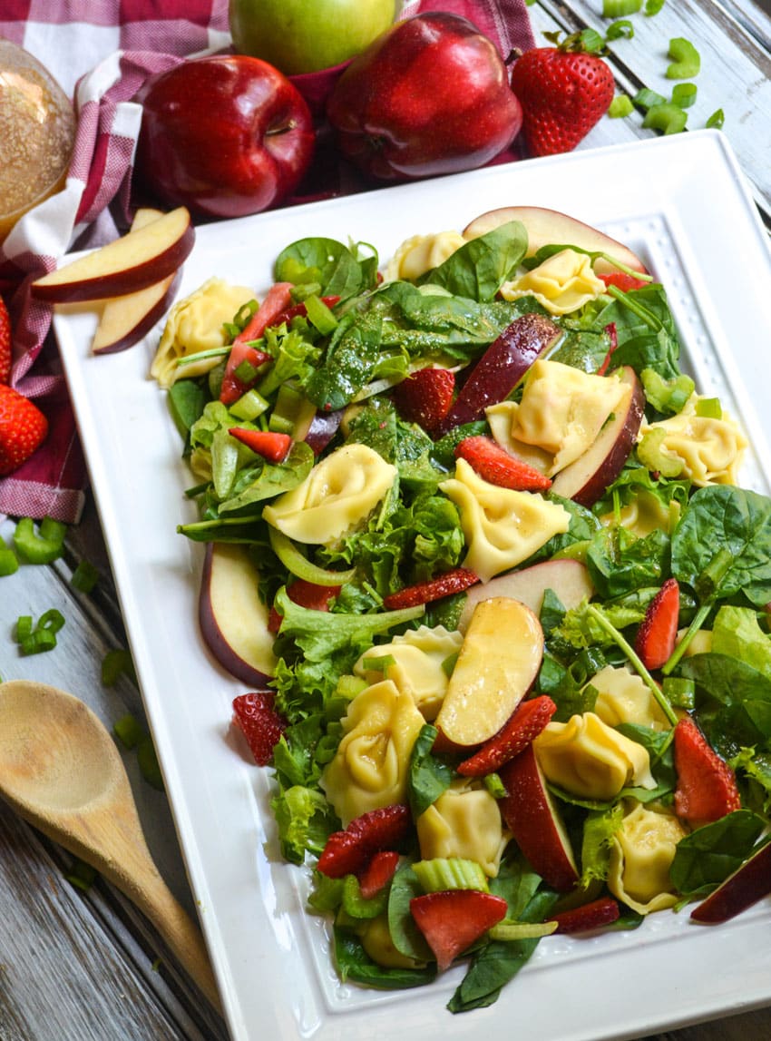 Apple Tortellini Salad With Strawberries on a large white serving platter