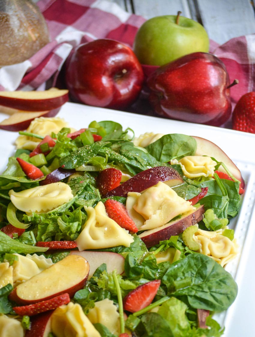 Apple Tortellini Salad With Strawberries on a large white serving platter