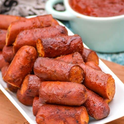smoked hot dog burnt ends piled on a small white serving platter