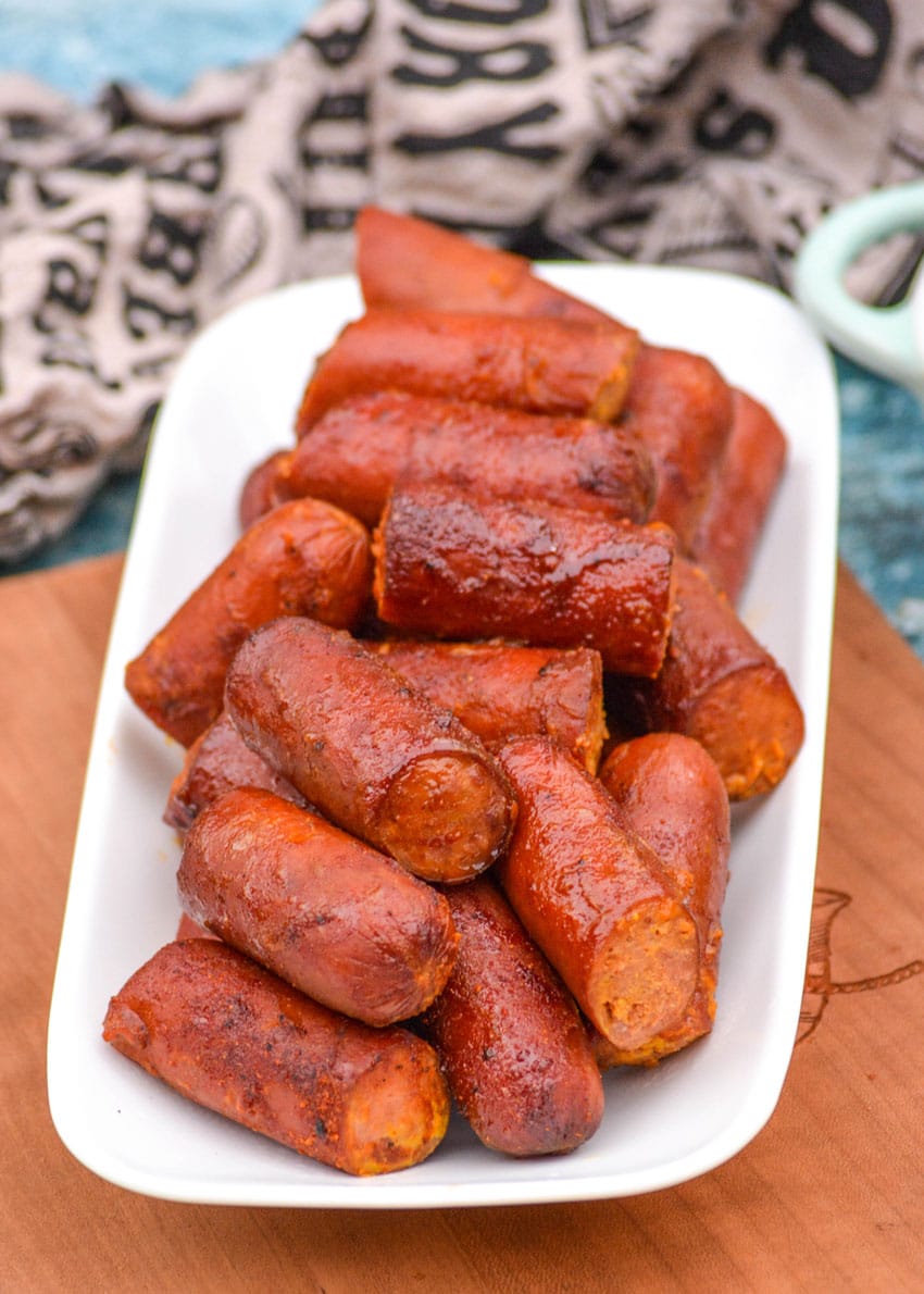 smoked hot dog burnt ends piled on a small white serving platter
