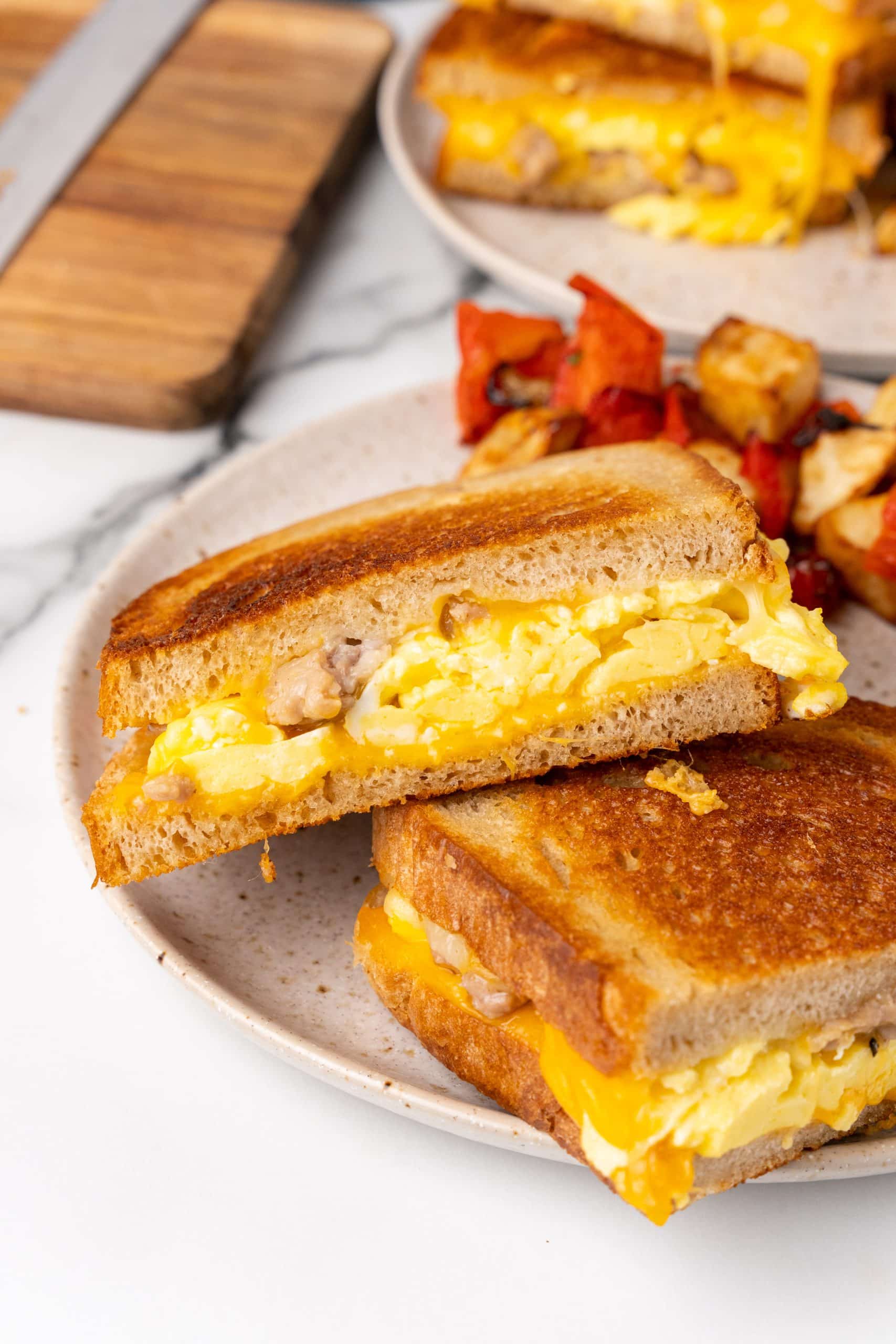 a breakfast grilled cheese sandwich on a white plate