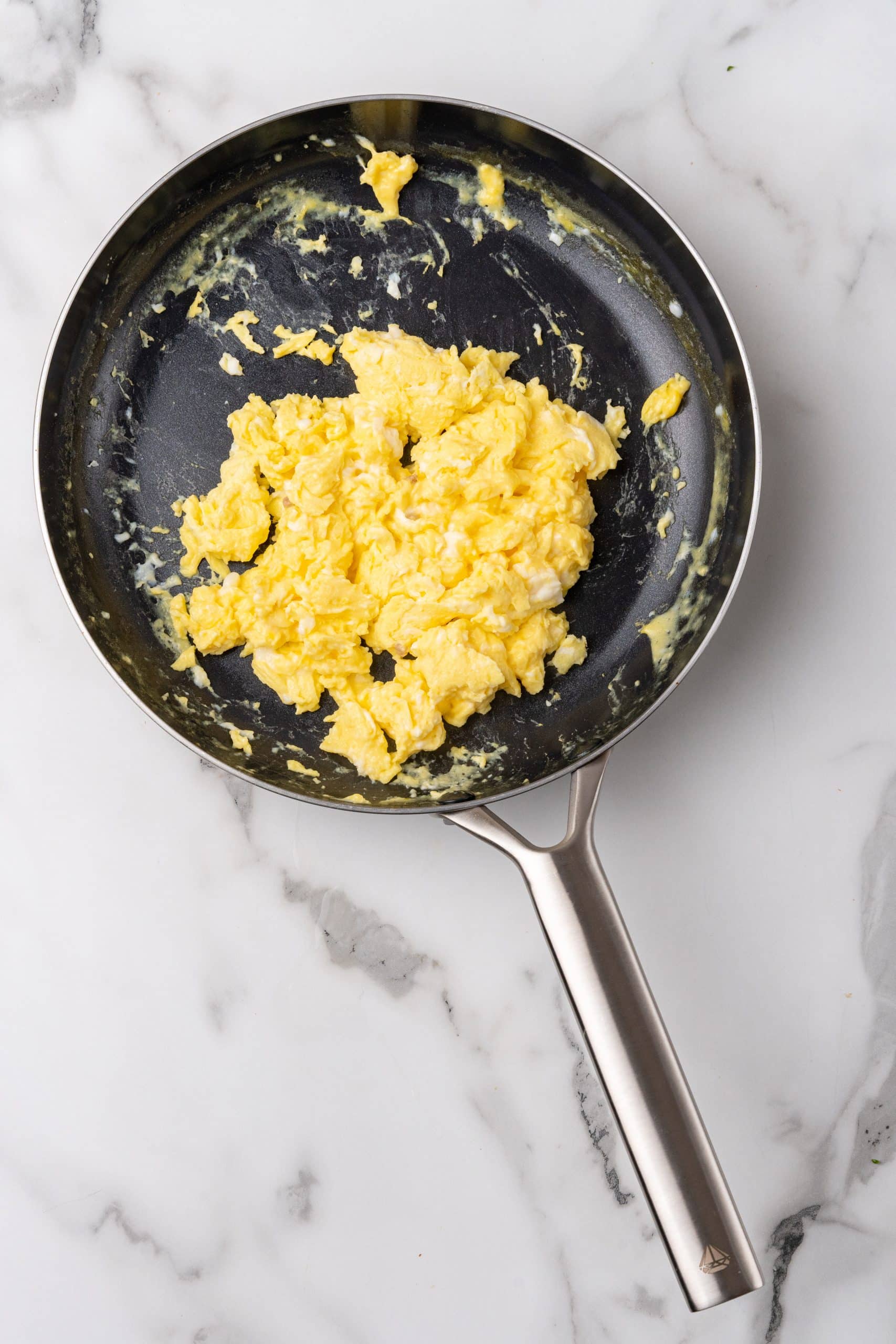 scrambled eggs in a small black skillet