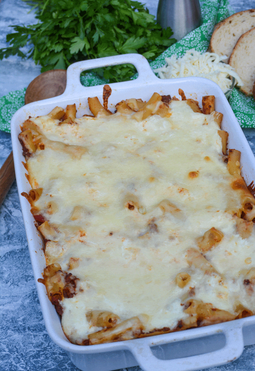 cheesy baked ziti casserole in a white baking dish