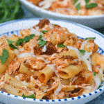 easy baked ziti recipe in two bowls with slices of crusty bread on the side