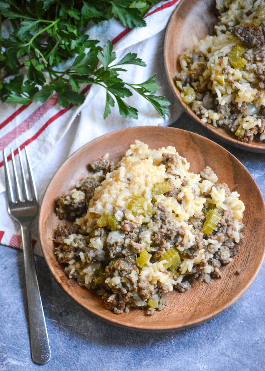 ground beef and rice casserole served on two small wooden plates