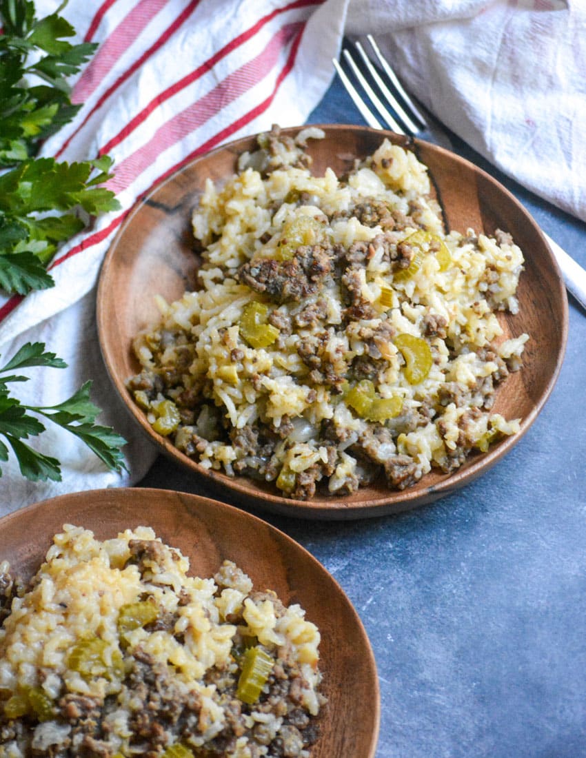 ground beef and rice casserole served on two small wooden plates