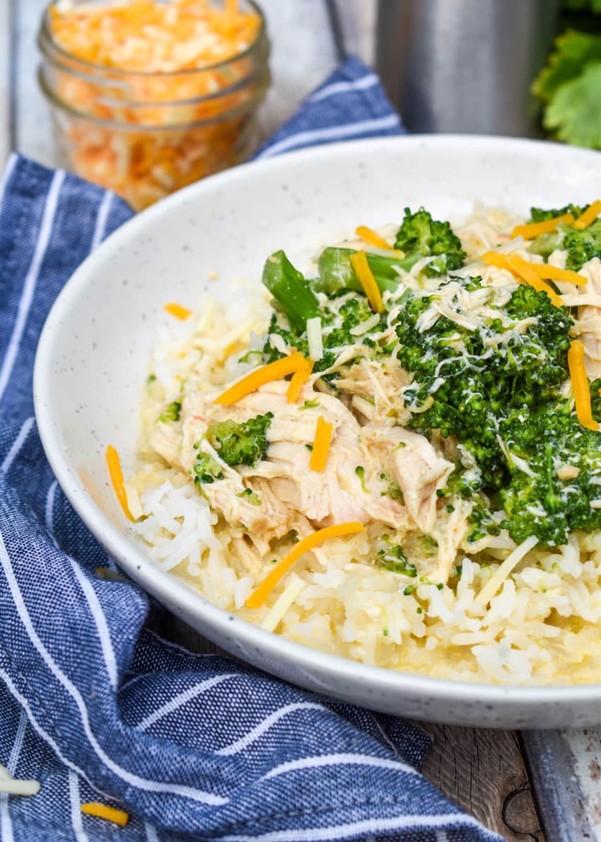 slow cooker chicken and broccoli over rice in a white bowl