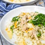 slow cooker chicken and broccoli over rice in a white bowl