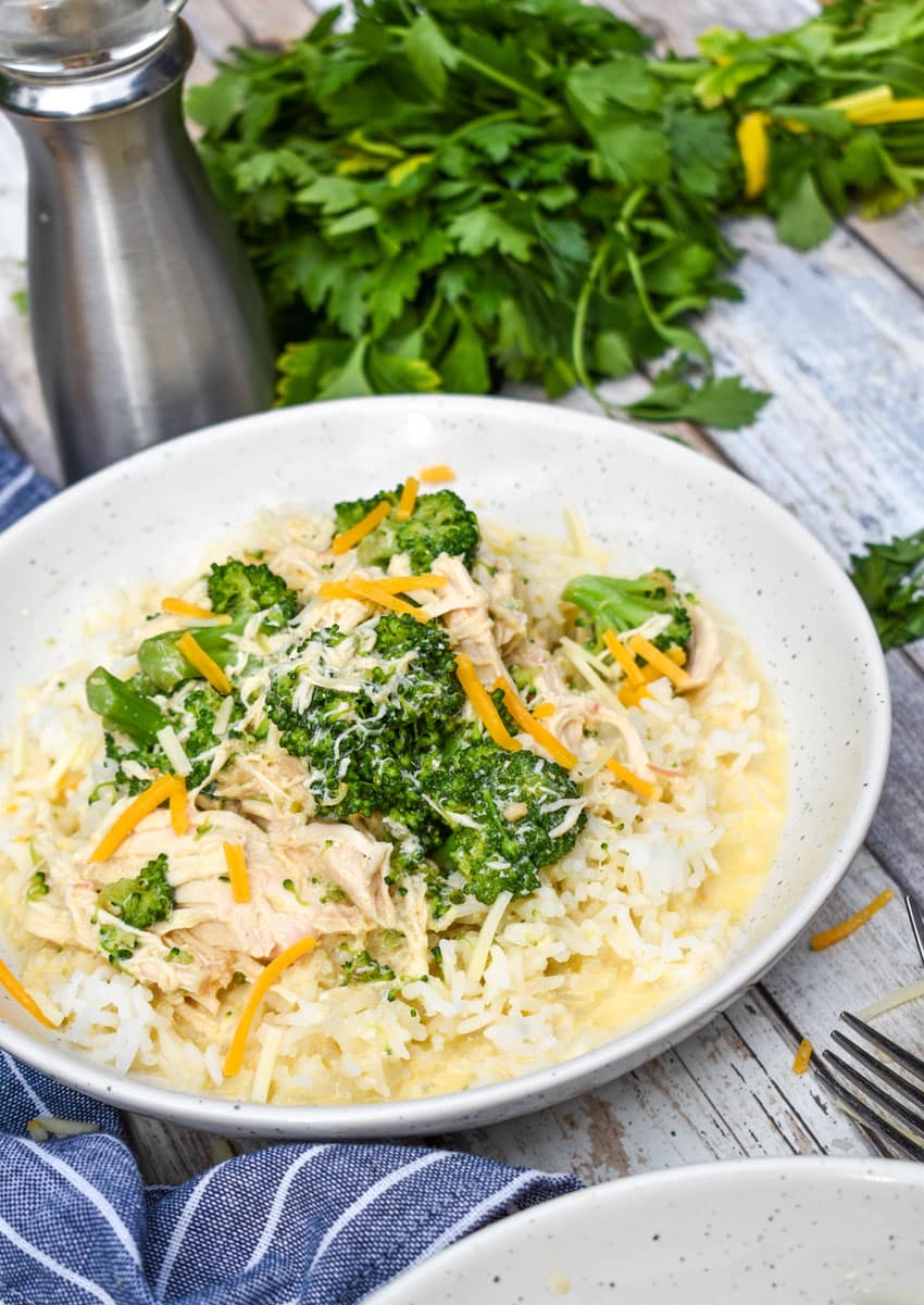 slow cooker chicken and broccoli over rice in a white bowl
