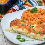 creamy white chicken enchiladas on a white plate