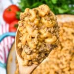 a wooden spoon holding up a scoop of creamy hamburger helper from scratch