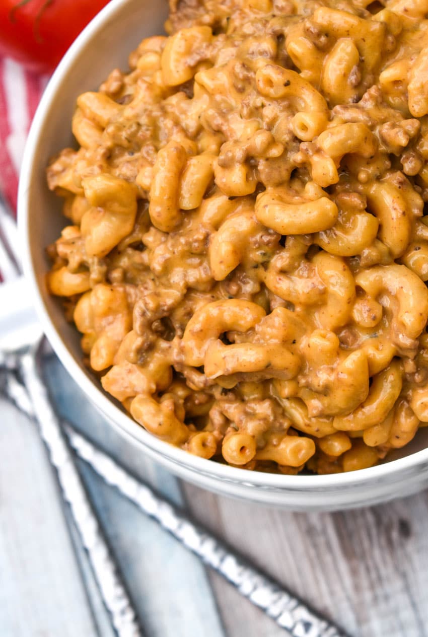 extra creamy hamburger helper from scratch in a white bowl with two silver forks on the side