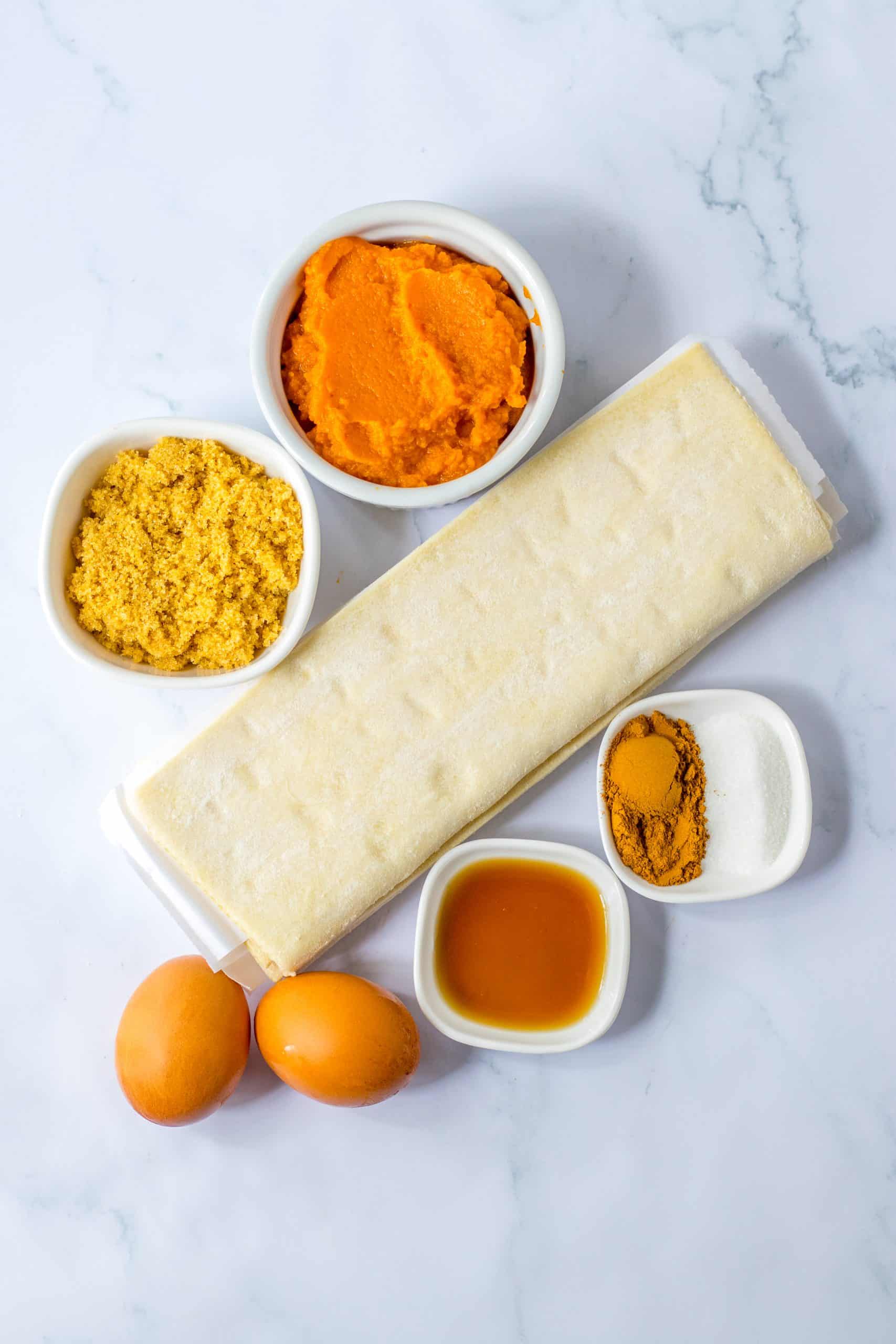 an overhead image showing the measured ingredients needed to make a batch of pumpkin pie crescent rolls