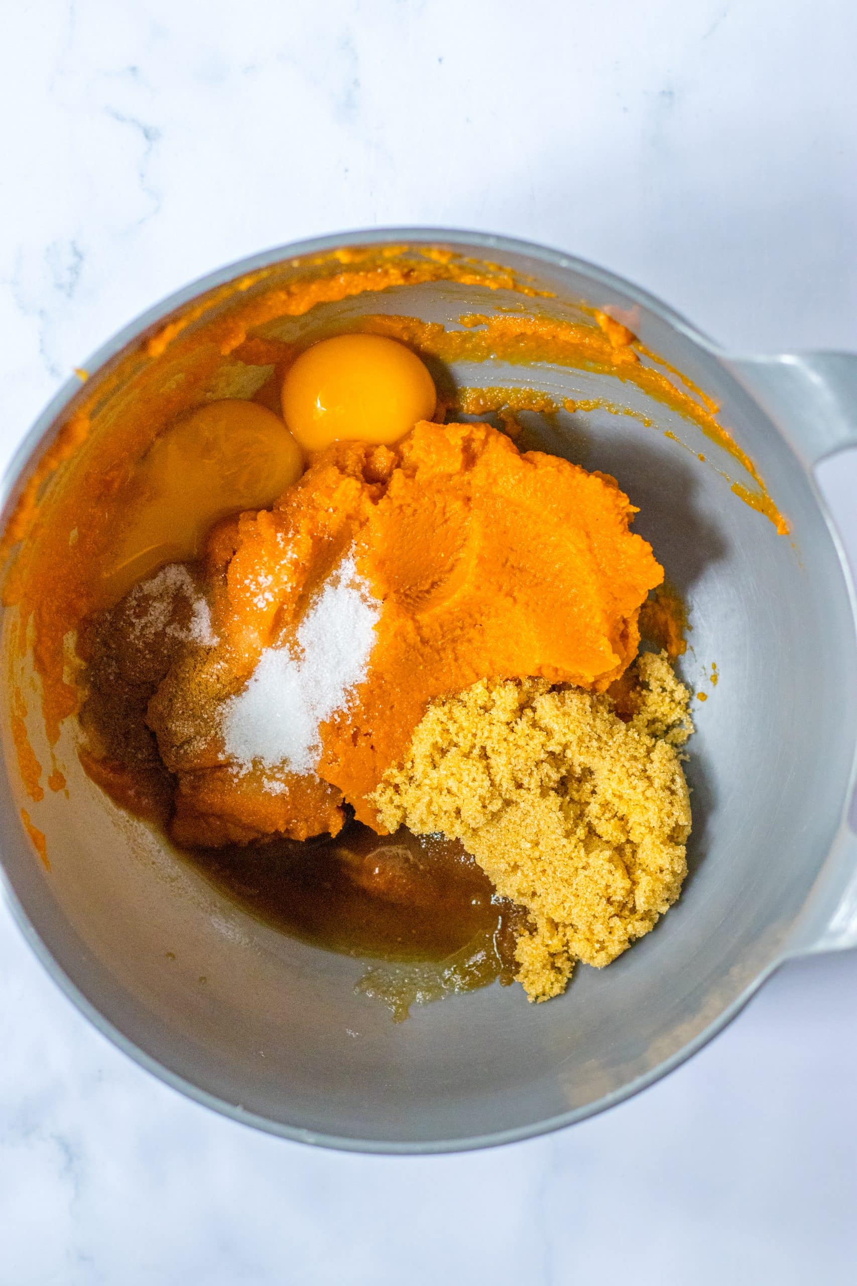 pumpkin pie filling ingredients in a large mixing bowl