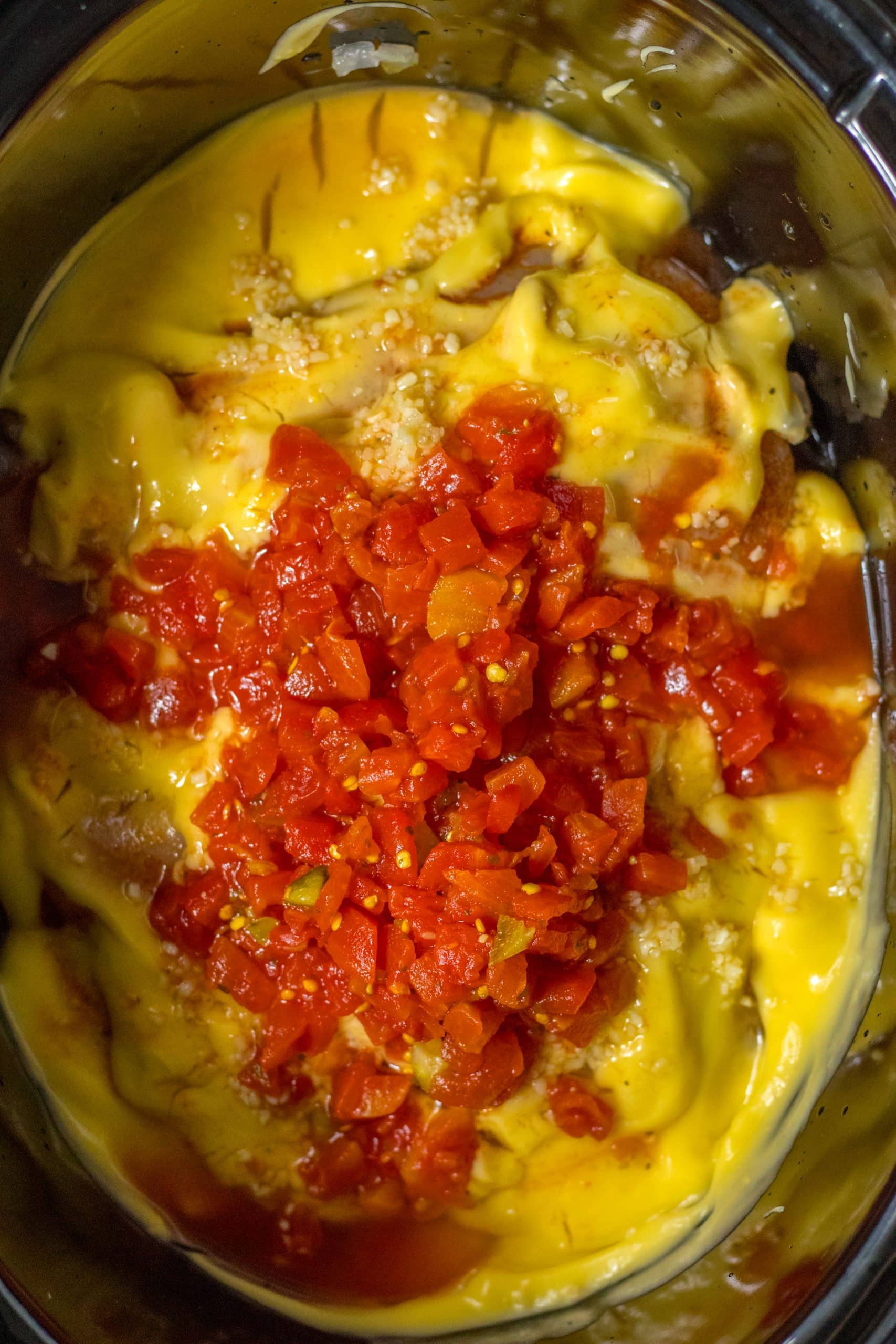 slow cooker chicken spaghetti ingredients in the black bowl of a crockpot